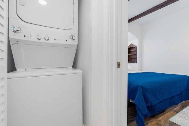 washroom with dark wood-type flooring and stacked washing maching and dryer