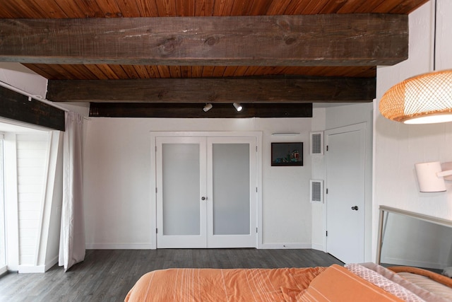 unfurnished bedroom with beam ceiling, dark wood-type flooring, and wood ceiling