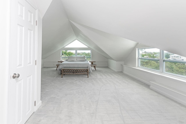 carpeted bedroom featuring lofted ceiling