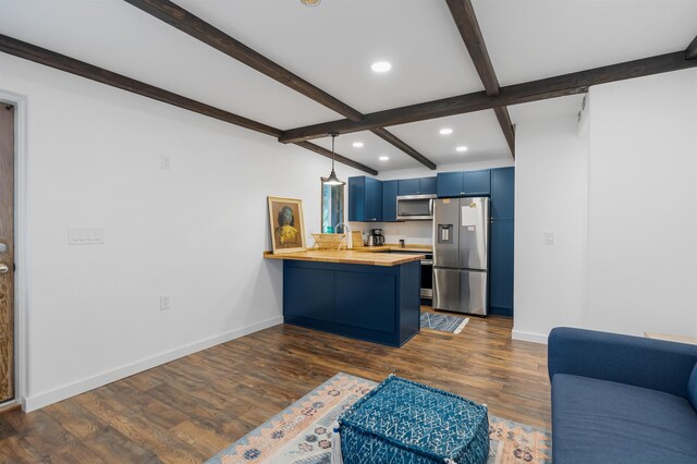 kitchen featuring stainless steel appliances, blue cabinets, kitchen peninsula, wooden counters, and beam ceiling