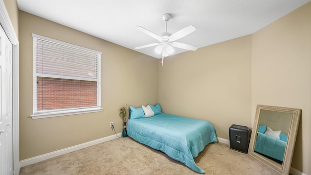 bedroom with ceiling fan, a closet, and light carpet