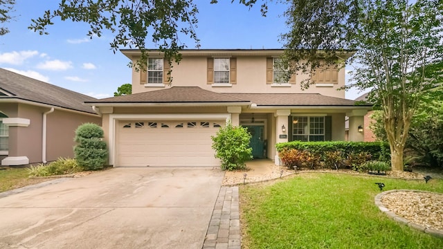 view of front of property with a front yard and a garage