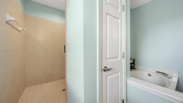 bathroom featuring shower with separate bathtub