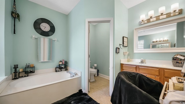 bathroom featuring vanity, lofted ceiling, a bathing tub, tile patterned flooring, and toilet