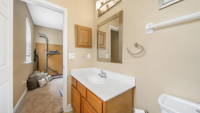 bathroom featuring vanity and toilet