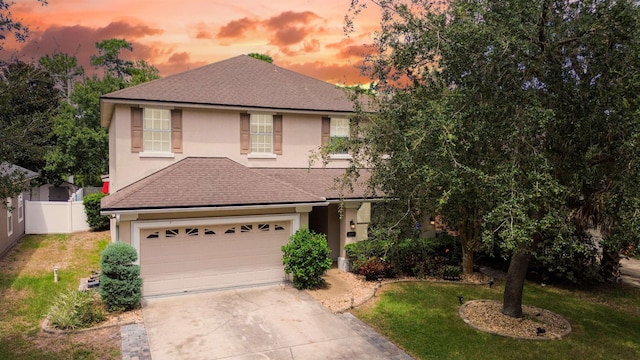 view of front of property featuring a lawn and a garage