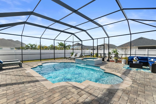 view of swimming pool with an in ground hot tub, a lanai, an outdoor living space, and a patio