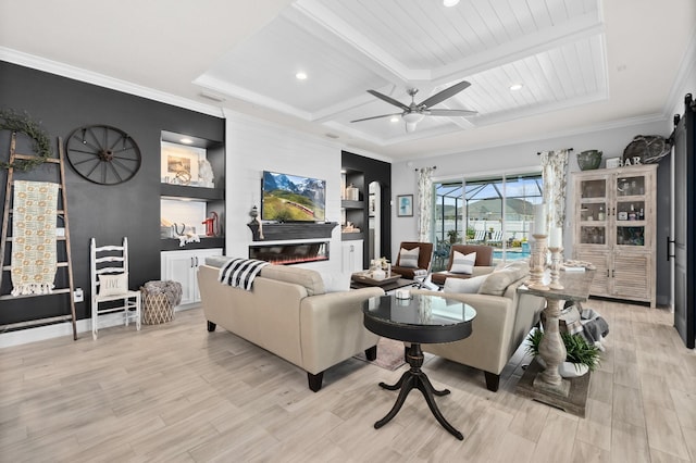 living room with beamed ceiling, light wood-type flooring, a large fireplace, built in features, and ceiling fan