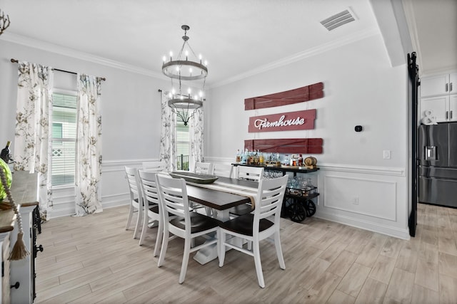 dining space featuring a chandelier and ornamental molding