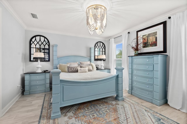 bedroom with a notable chandelier, crown molding, and light hardwood / wood-style floors