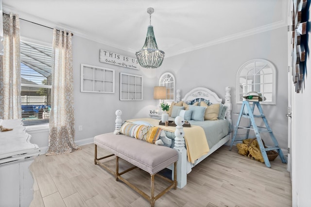 bedroom featuring ornamental molding, light wood-type flooring, and an inviting chandelier