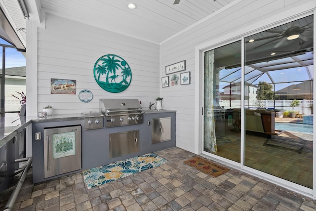 view of patio / terrace featuring a grill, a lanai, and area for grilling