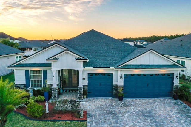 craftsman-style house with a garage and french doors