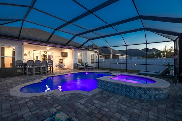 view of pool with an in ground hot tub, a lanai, an outdoor bar, and a patio