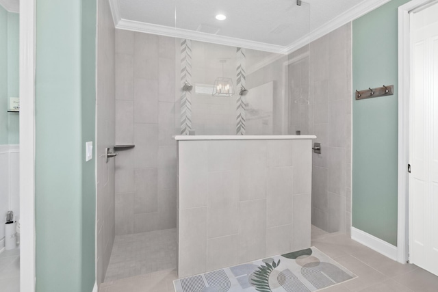 bathroom featuring a tile shower, tile patterned floors, and ornamental molding