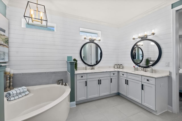 bathroom featuring vanity, a washtub, and tile patterned flooring