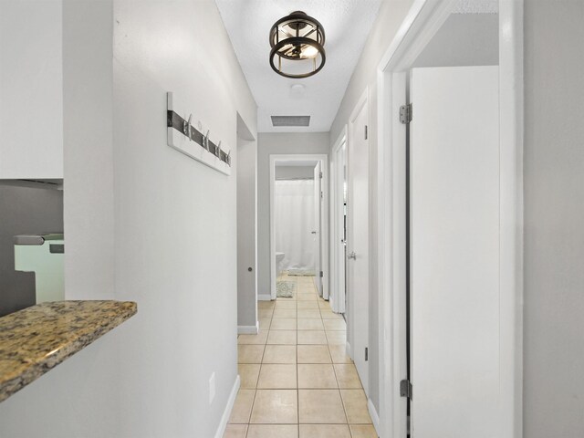 129 Rio Del Mar St Unit C, Saint Augustine, FL 32080 - corridor with baseboards and light tile patterned floors