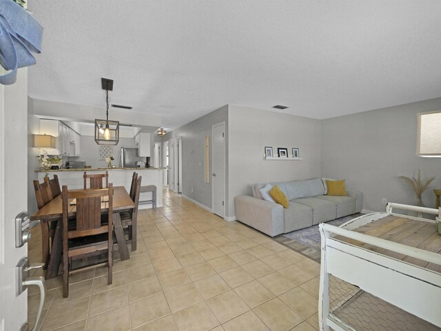 129 Rio Del Mar St Unit C, Saint Augustine, FL 32080 - living area featuring light tile patterned floors and a textured ceiling