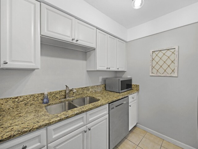 129 Rio Del Mar St Unit C, Saint Augustine, FL 32080 - kitchen featuring stainless steel appliances, a sink, white cabinets, and light stone counters
