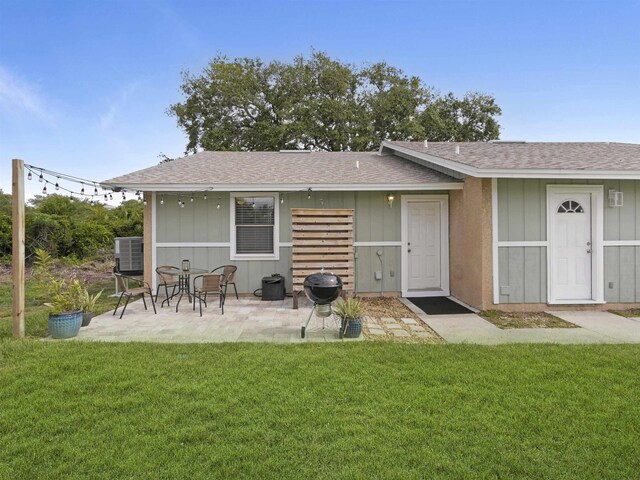 129 Rio Del Mar St Unit C, Saint Augustine, FL 32080 - rear view of property featuring a shingled roof, a yard, and a patio area