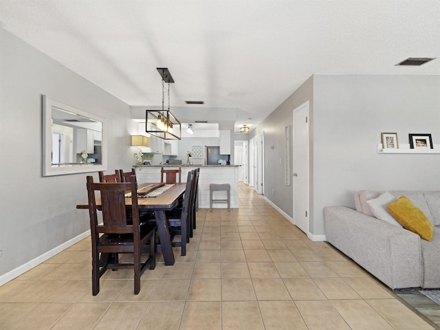 129 Rio Del Mar St Unit C, Saint Augustine, FL 32080 - dining space with light tile patterned floors and baseboards