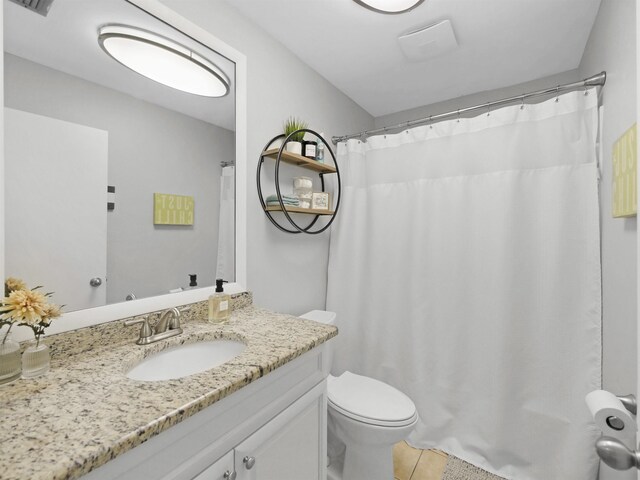 129 Rio Del Mar St Unit C, Saint Augustine, FL 32080 - full bathroom with vanity, toilet, tile patterned flooring, and curtained shower