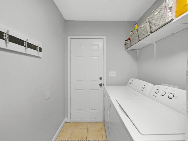 129 Rio Del Mar St Unit C, Saint Augustine, FL 32080 - laundry room with independent washer and dryer, light tile patterned flooring, and baseboards
