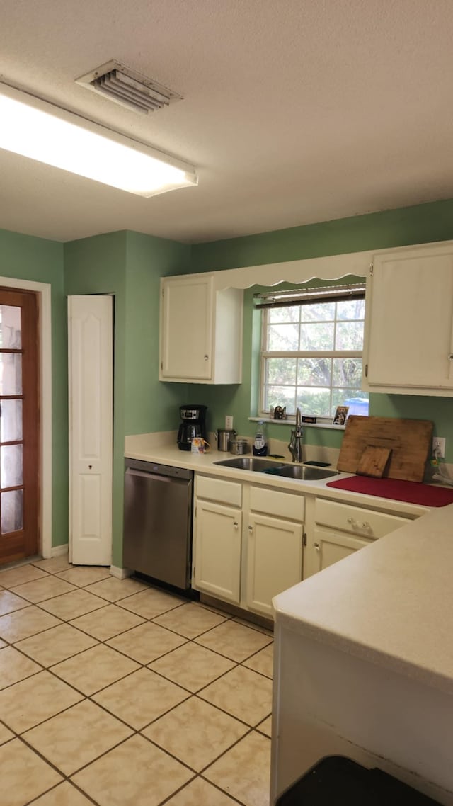 kitchen with visible vents, a sink, light countertops, white cabinets, and dishwasher