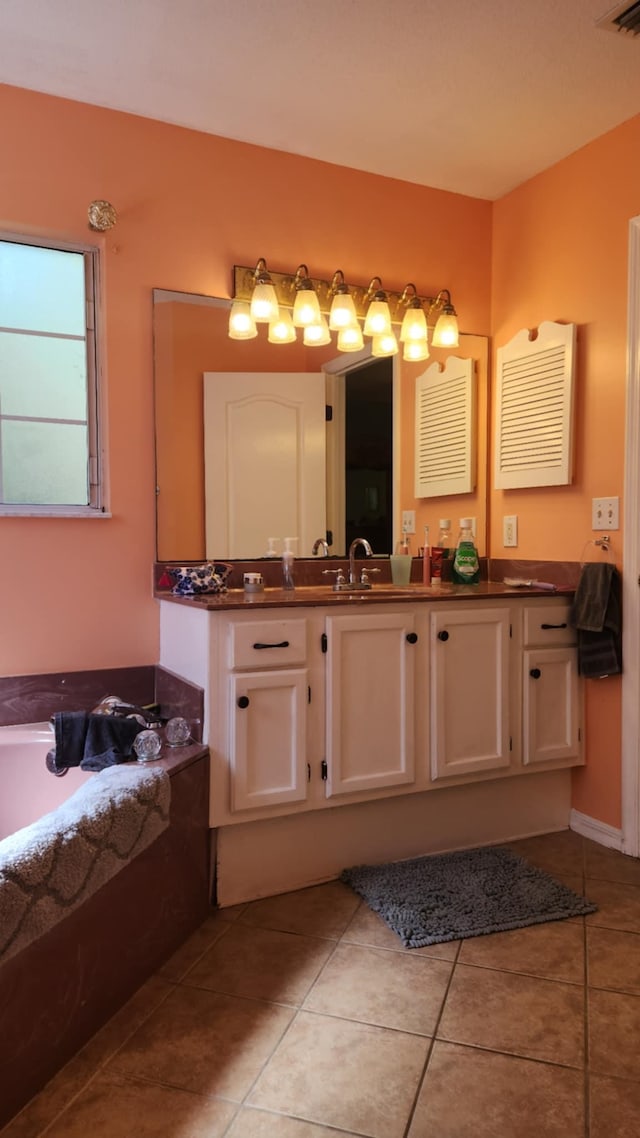 full bath with tile patterned flooring, visible vents, vanity, and a garden tub