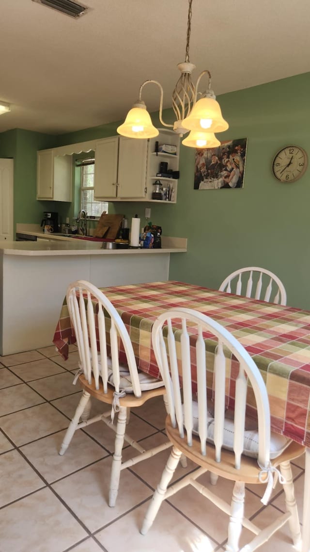 dining room featuring light tile patterned flooring and visible vents