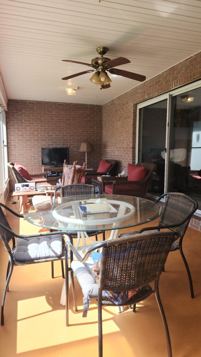 sunroom / solarium featuring ceiling fan