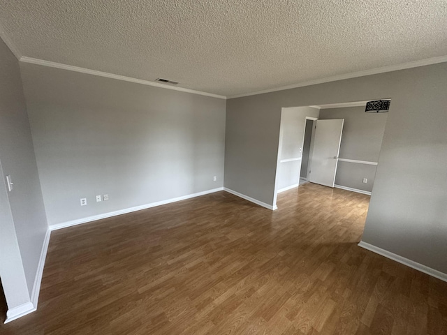 spare room with ornamental molding, a textured ceiling, and dark hardwood / wood-style flooring