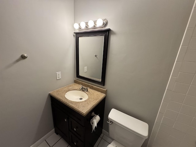 bathroom with vanity, toilet, and tile patterned flooring