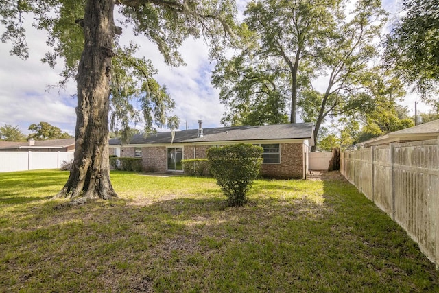 rear view of property with a yard