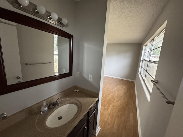 bathroom with vanity, hardwood / wood-style floors, and a textured ceiling