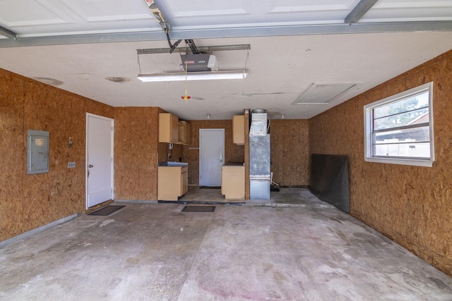 garage featuring a garage door opener, electric panel, and wood walls