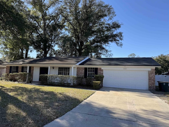 ranch-style house featuring a garage and a front lawn