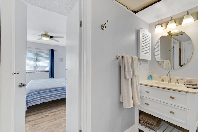 4250 A1A S B36, Saint Augustine, FL 32080 - ensuite bathroom with vanity, wood finished floors, ceiling fan, and a textured ceiling