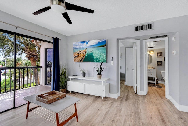 4250 A1A S B36, Saint Augustine, FL 32080 - living room featuring a ceiling fan, light wood-style flooring, and a textured ceiling