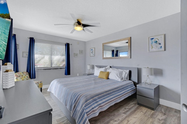 4250 A1A S B36, Saint Augustine, FL 32080 - bedroom featuring light wood-type flooring, ceiling fan, and a textured ceiling