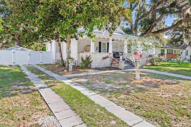 bungalow-style house with a front lawn and a porch