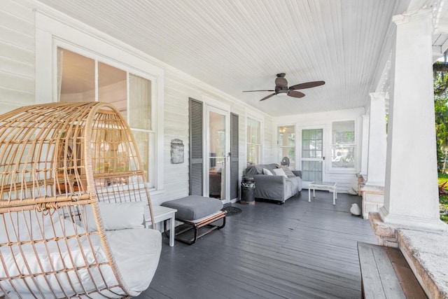 sunroom featuring decorative columns and ceiling fan