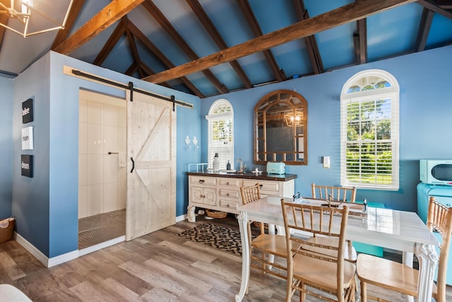 bathroom featuring hardwood / wood-style floors, beam ceiling, sink, and high vaulted ceiling