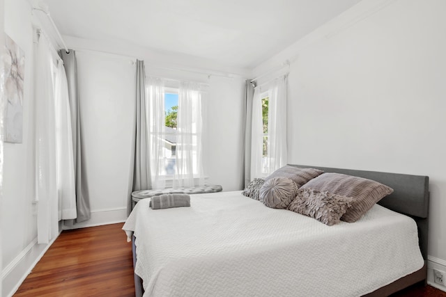 bedroom with dark hardwood / wood-style flooring