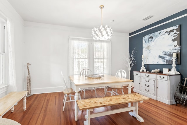 dining room featuring a chandelier and light hardwood / wood-style floors