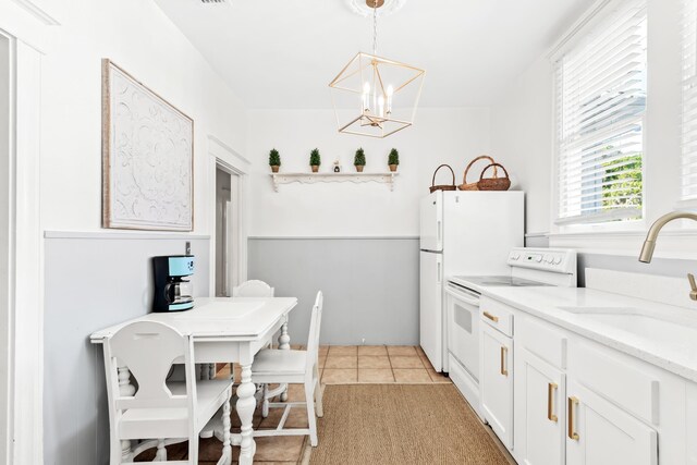 clothes washing area with cabinets, crown molding, light tile patterned floors, and stacked washing maching and dryer