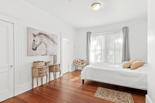 bedroom featuring hardwood / wood-style floors and ornamental molding