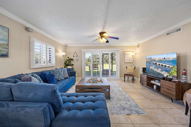 living room featuring light tile patterned floors, a textured ceiling, ceiling fan, and crown molding