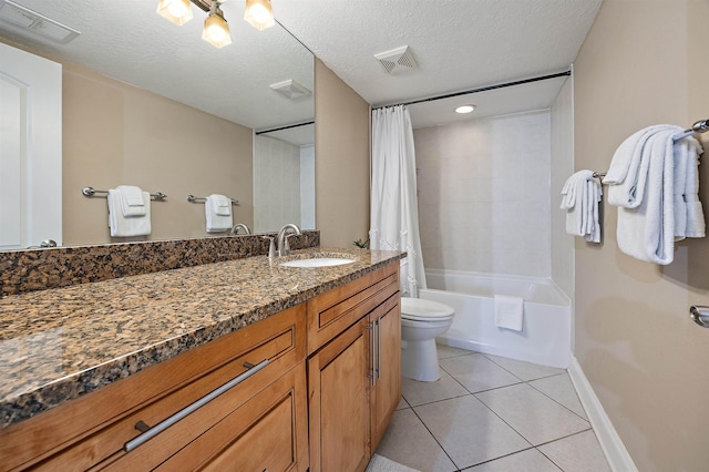 full bathroom with vanity, tile patterned floors, toilet, shower / bath combo with shower curtain, and a textured ceiling