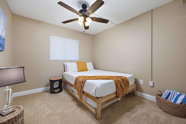 bedroom with ceiling fan and light carpet